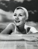 Close-up of a young woman leaning on the edge of swimming pool and smiling Poster Print - Item # VARSAL25521109C