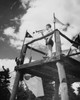 Low angle view of a teenage boy blowing a bugle at a scout camp Poster Print - Item # VARSAL25517494