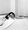 Mother embracing daughter in bed Poster Print - Item # VARSAL255417752