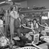 Father testing mechanical lawn mower while mother and daughter are watching Poster Print - Item # VARSAL255421091