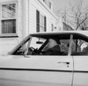Man sitting in car outside house Poster Print - Item # VARSAL255424897