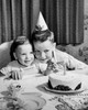 High angle view of two boys sitting in front of a birthday cake and smiling Poster Print - Item # VARSAL255728C