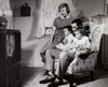 Parents with their two daughters watching television Poster Print - Item # VARSAL2551046