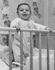 Baby smiling and standing in a crib Poster Print - Item # VARSAL2559640