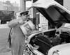 Mechanic pouring oil into car engine Poster Print - Item # VARSAL255422438