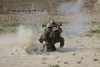US Marine watches a U.S. Contractor fire a HE fragmentation round from the RPG-7 rocket-propelled grenade launcher in a wadi near Kunduz, Afghanistan Poster Print - Item # VARPSTTMO100320M