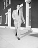 Young man walking on sidewalk Poster Print - Item # VARSAL255419247