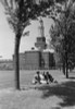 Three students sitting on grass outside university building Poster Print - Item # VARSAL255422984