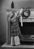 Girl hanging Christmas stocking on mantelpiece Poster Print - Item # VARSAL255422888