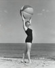 Side profile of young woman holding beach ball on beach Poster Print - Item # VARSAL25521150