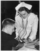 Female nurse checking a young man's blood pressure Poster Print - Item # VARSAL25515225