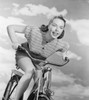 Young woman riding bicycle against cloudy sky Poster Print - Item # VARSAL255422993C