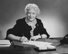 Businesswoman writing on documents with a pen in an office Poster Print - Item # VARSAL25528043