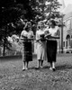 Three female students walking in front of university building and talking Poster Print - Item # VARSAL255419263