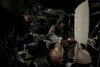 U.S. Army Medevac Crew Chief assists the flight medic by simulating ventilation of a mock patient during training _aboard a UH-60L Black Hawk helicopter Poster Print - Item # VARPSTTMO100910M