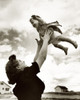 Side profile of a mother tossing her daughter in the air Poster Print - Item # VARSAL2556012B