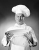 Studio portrait of chef holding plate Poster Print - Item # VARSAL255420897