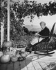 Senior woman sitting in a rocking chair and peeling an apple Poster Print - Item # VARSAL25549054