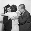 Parents embracing daughter at graduation Poster Print - Item # VARSAL255417904