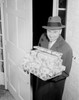 Man carrying Christmas presents in doorway Poster Print - Item # VARSAL255422263