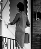 Young woman standing in front of entrance door using doorbell Poster Print - Item # VARSAL255417820