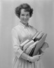 Portrait of a smiling teenage girl holding books Poster Print - Item # VARSAL2557079