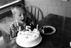 Boy blowing at candle on birthday cake Poster Print - Item # VARSAL255423020