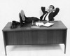 Businessman resting in an office with his feet up Poster Print - Item # VARSAL25548382