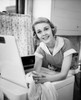 Portrait of young woman leaning on washing machine Poster Print - Item # VARSAL25541898