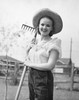 Portrait of a young woman holding a rake and smiling Poster Print - Item # VARSAL2552321