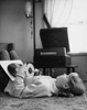 Girl lying on a carpet and holding records  1965 Poster Print - Item # VARSAL2552592B