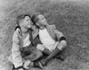 Two boys sitting on the grass with their arms around each other Poster Print - Item # VARSAL25516249