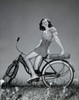 Teenage girl sitting on a bicycle and smiling Poster Print - Item # VARSAL25517495