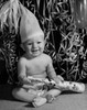Portrait of a baby boy holding a noisemaker and smiling Poster Print - Item # VARSAL255647