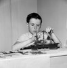 Boy building ship model Poster Print