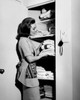 Side profile of a young woman putting towels in a cabinet Poster Print - Item # VARSAL2556204