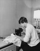 Mid adult woman sewing with a sewing machine Poster Print - Item # VARSAL25537554