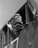 Low angle view of a train conductor smiling and waving Poster Print - Item # VARSAL2559531