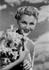 Portrait of young woman holding bunch of daffodils Poster Print - Item # VARSAL255416927