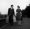 Young couple carrying suitcases at rail station Poster Print - Item # VARSAL255416576A