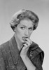 Mid adult woman biting her nails and looking away  studio shot Poster Print - Item # VARSAL255419933