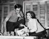 Mid adult woman holding a magazine and talking to a mid adult man Poster Print - Item # VARSAL25529325