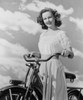 Portrait of young woman with bicycle against cloudy sky Poster Print - Item # VARSAL255422994A