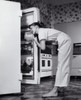 Side profile of a young woman looking in a refrigerator Poster Print - Item # VARSAL2559315