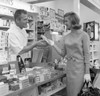 Young woman and pharmacist in pharmacy Poster Print - Item # VARSAL255421019