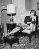 Mid adult woman reclining on an armchair Poster Print - Item # VARSAL25541855