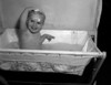 Small baby sitting in baby bathtub and smiling Poster Print - Item # VARSAL2559099