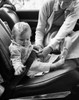 Mid adult woman fastening her daughter's car seat belt Poster Print - Item # VARSAL25544598 Mid adult woman fastening her daughter's car seat belt Poster Print - Item # VARSAL25544598