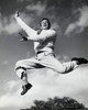 Low angle view of mid adult man jumping in mid air Poster Print - Item # VARSAL2553385B