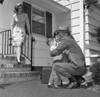 Mature man embracing children  wife standing on doorsteps and looking at them Poster Print - Item # VARSAL255417408